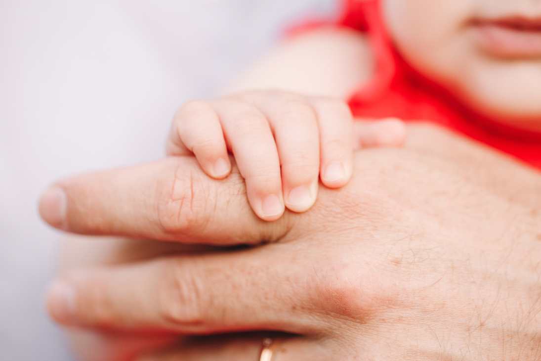 Person's Hand with Baby's Hand